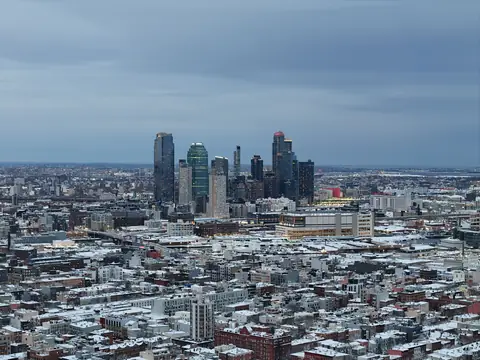 The towers of Long Island City in Queens seen from above over snow-covered rooftops