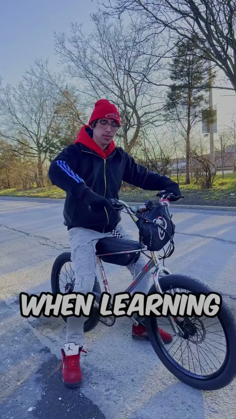 Christopher Maddaloni Jr. in a red beanie seated on an electric bike on an empty road, with the caption WHEN LEARNING