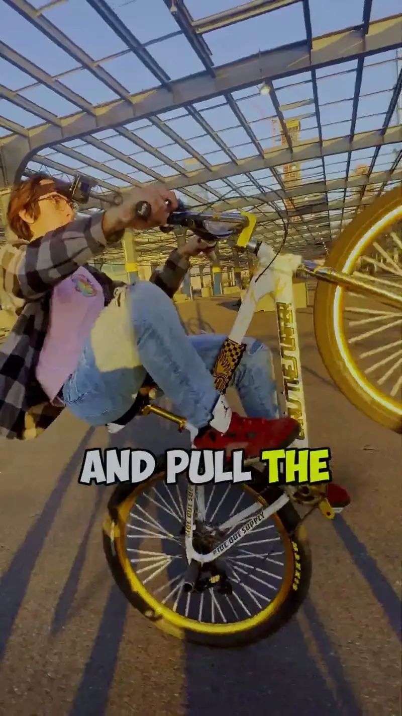 A frame from a ChrisTheSurfer Short: the rider leans back on a white bike with gold wheels, its front wheel in the air, with the caption AND PULL THE