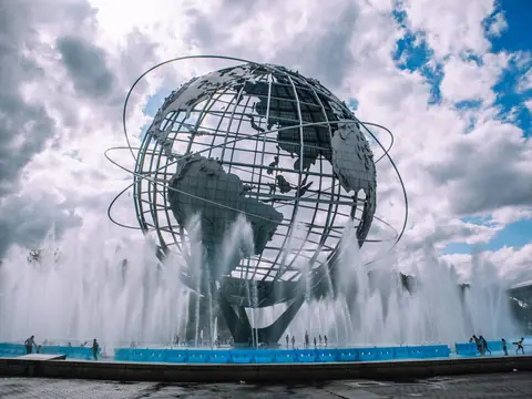 The Unisphere, the steel globe in Flushing Meadows in Queens, with its fountains running under a cloudy sky